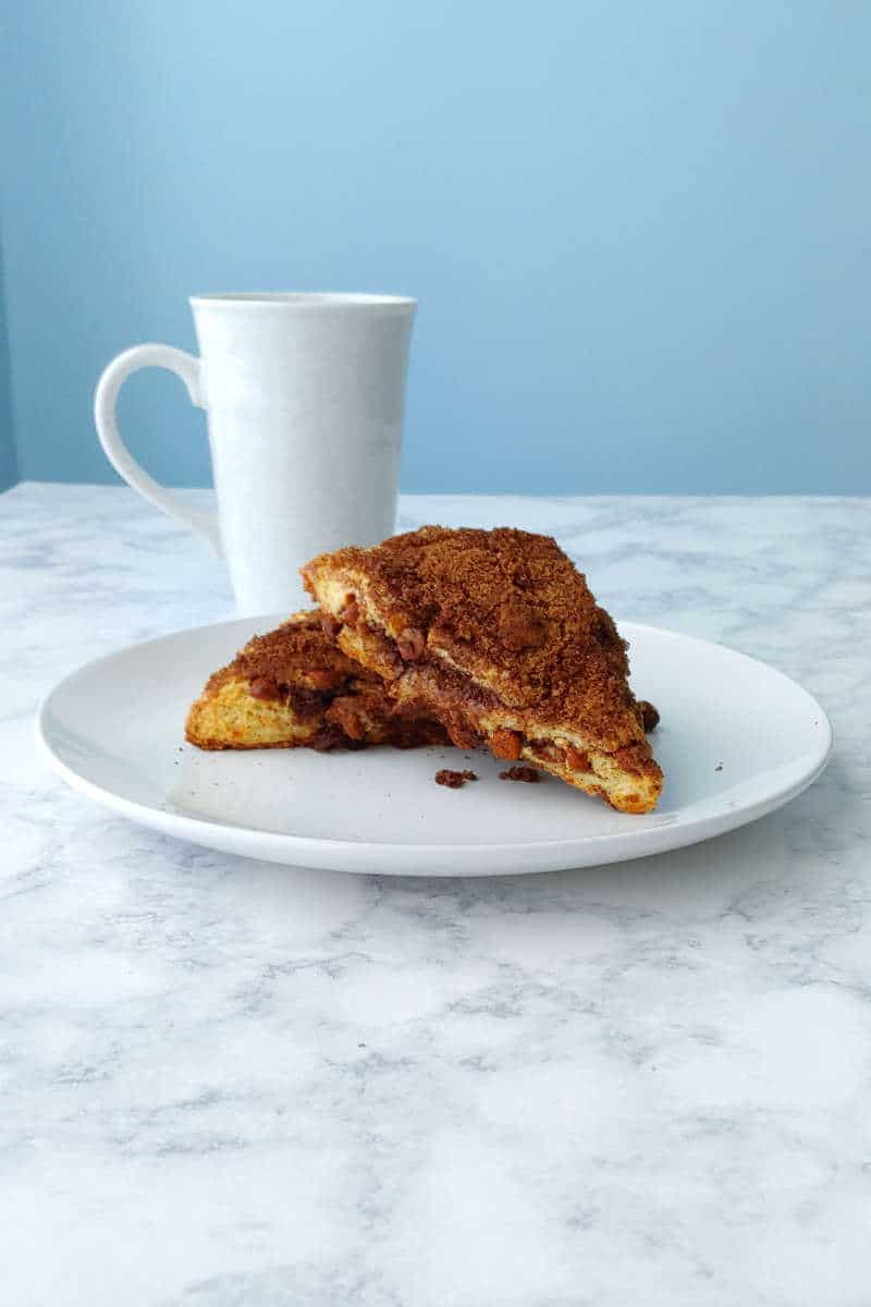 triple cinnamon scones, on a plate with a mug next to them