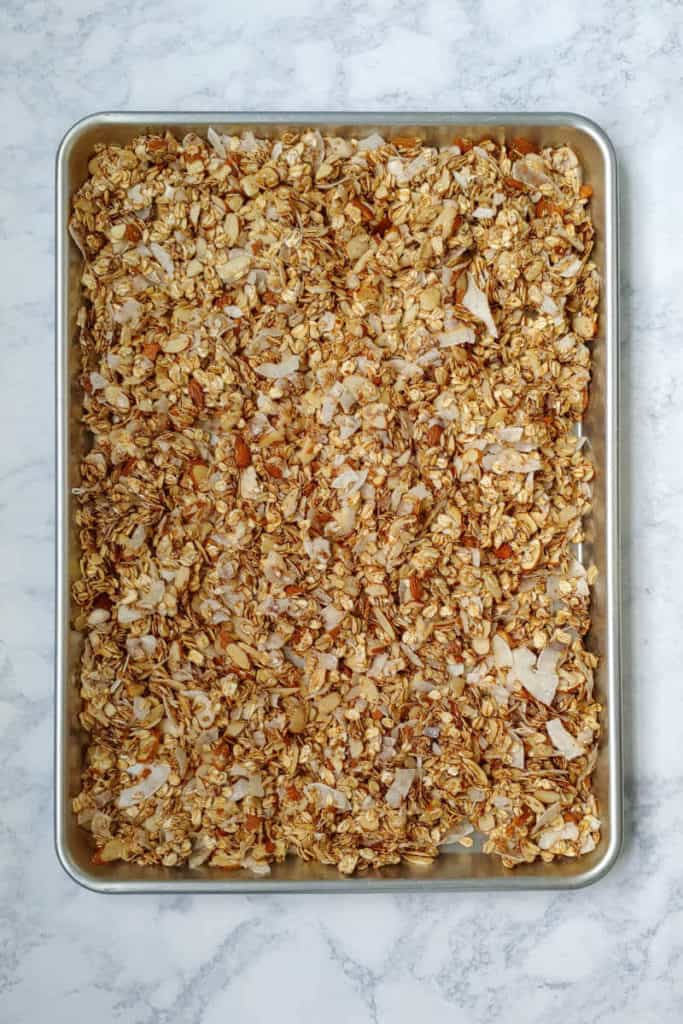 cherry, almond, and cinnamon granola, on the baking sheet before toasting