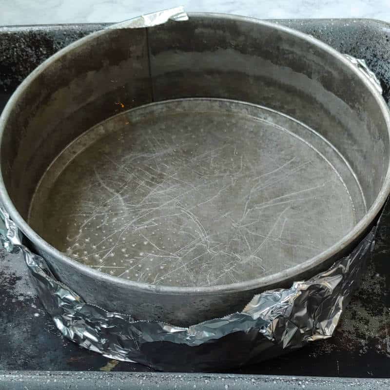 springform pan lined with foil, in a larger baking pan