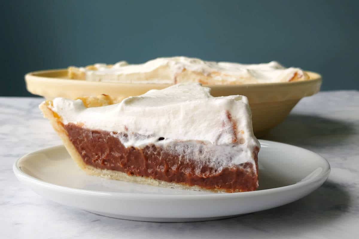 a slice of chocolate cream pie, on a plate