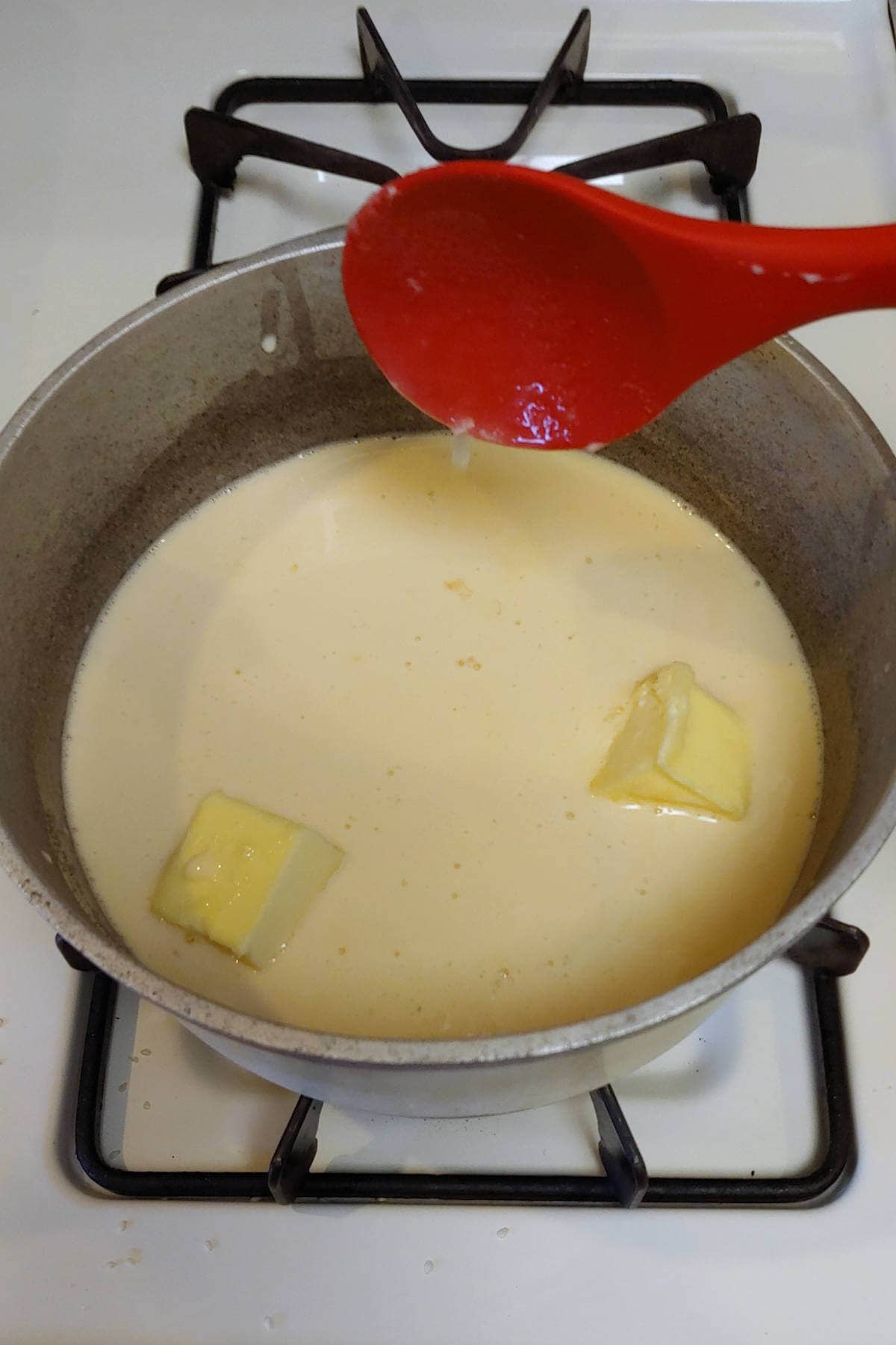 butter, milk, and sugar in a pot on the stove