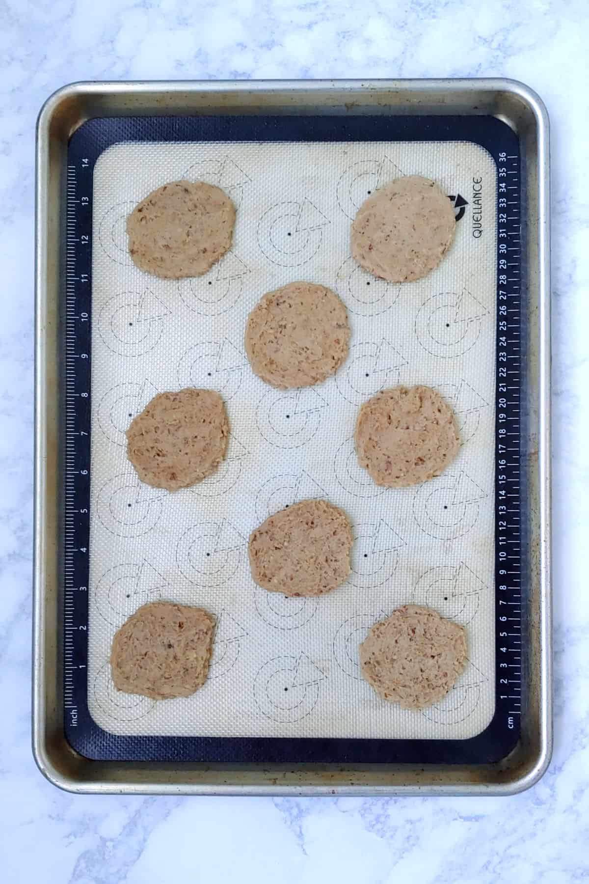 cookie dough, flattened out, before being baked 10 minutes