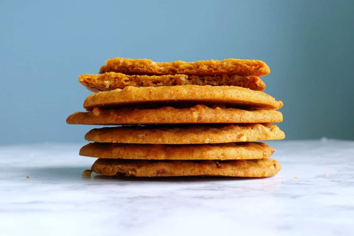 a stack of butterscotch cookies, with one broken open to show texture