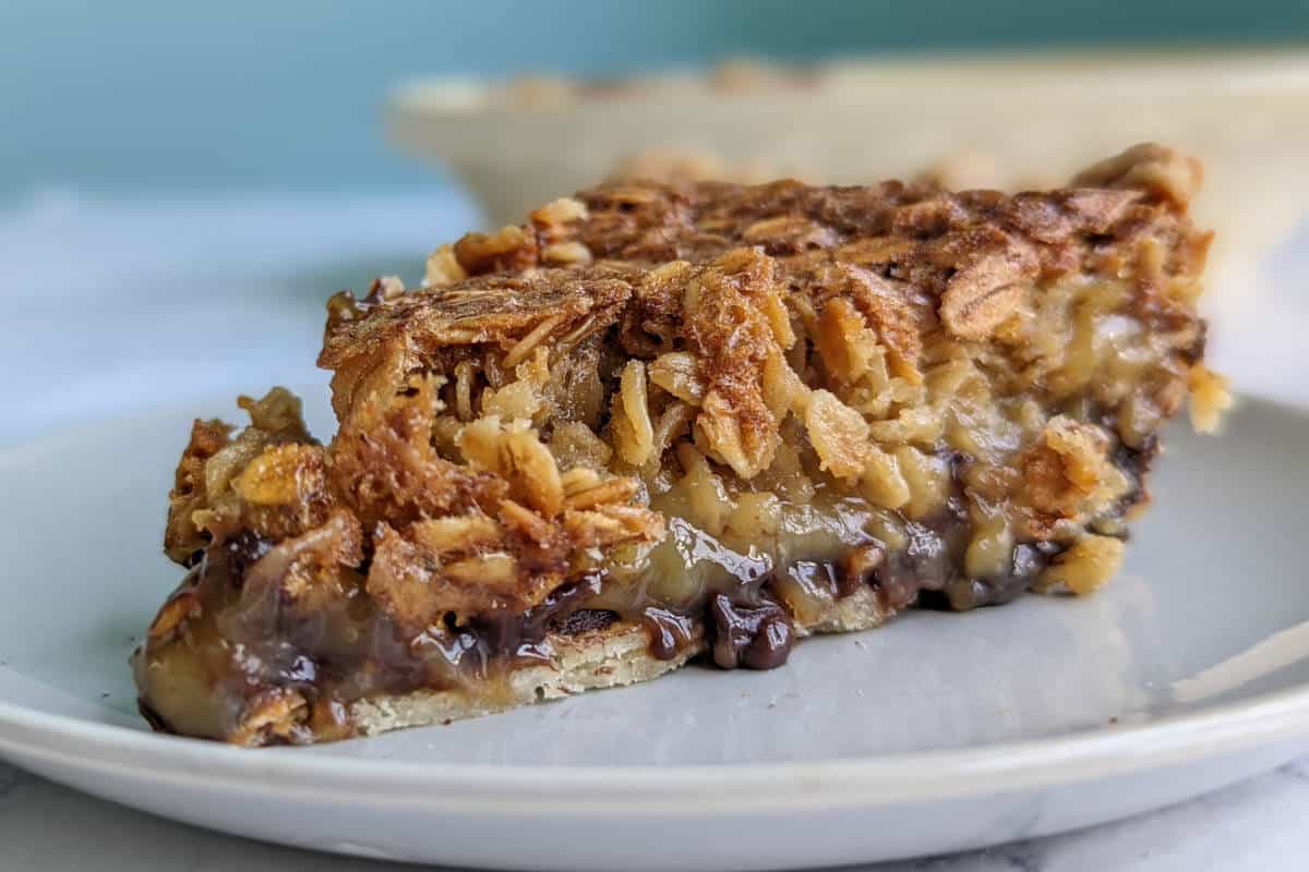 black bottom oatmeal pie slice, in front of pie dish