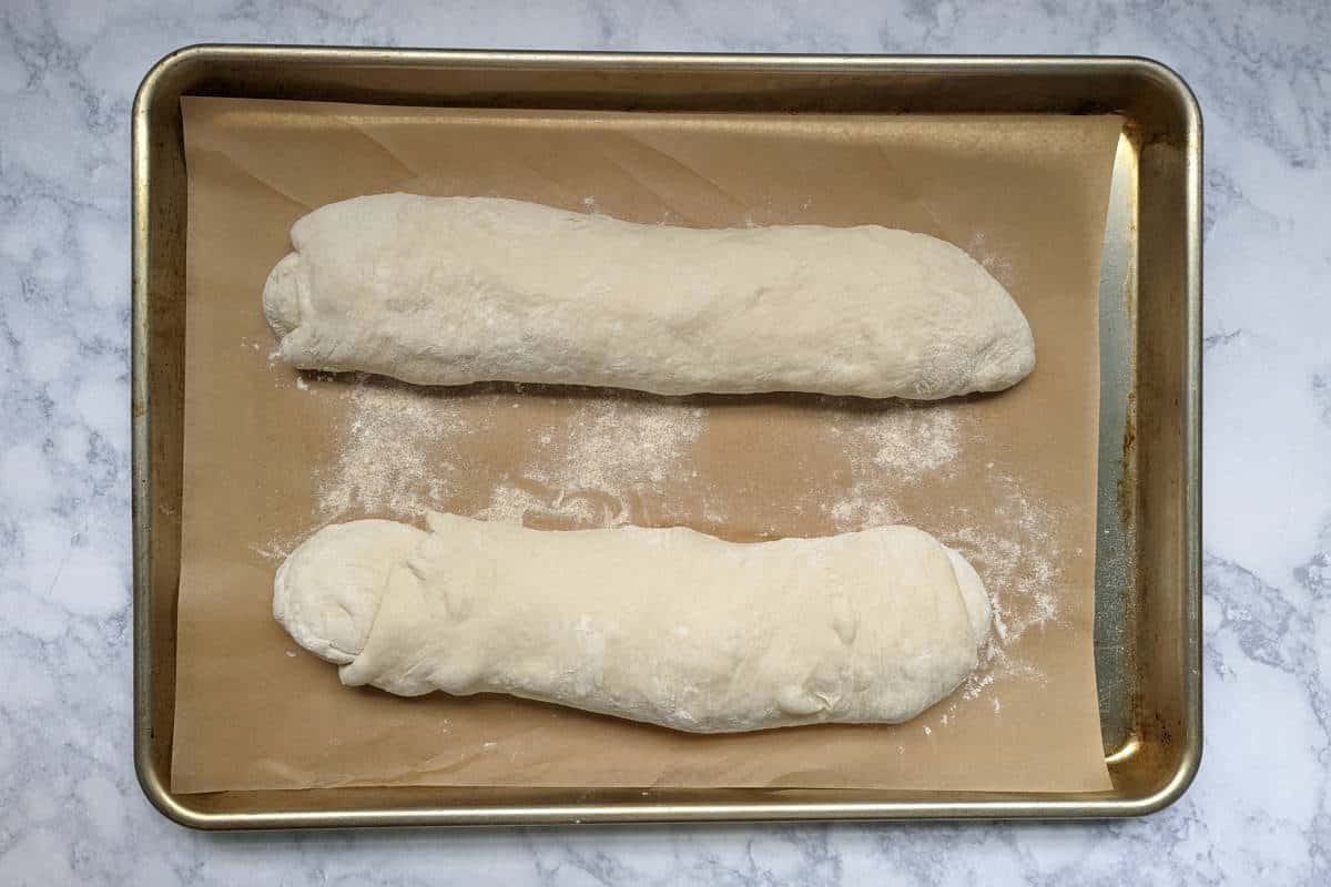loaves of italian bread dough, shaped, before rise