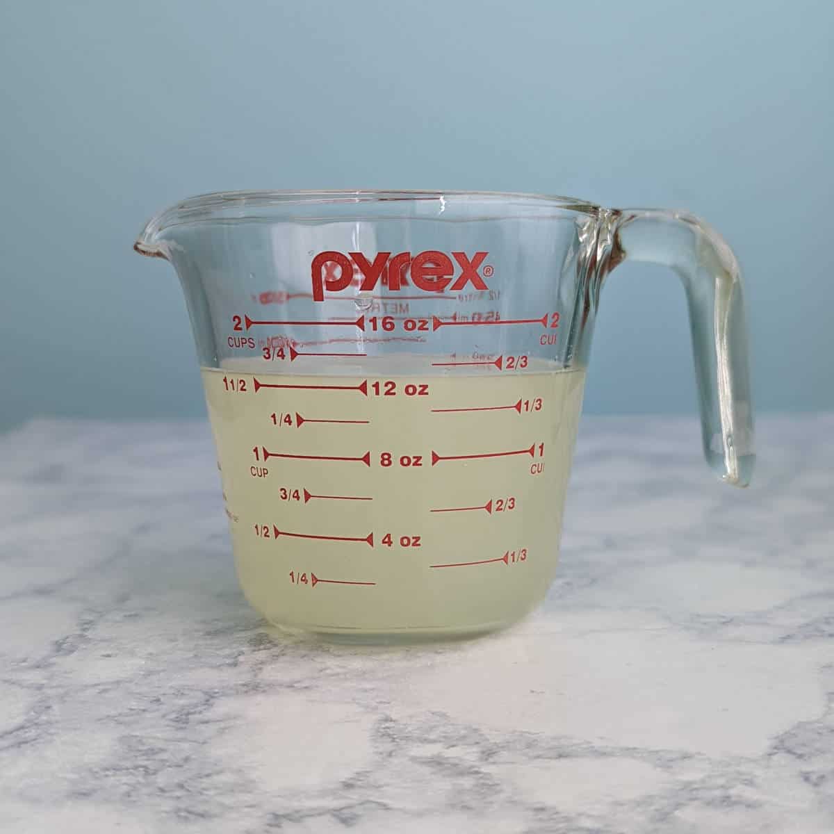 margarita mixture in a measuring cup