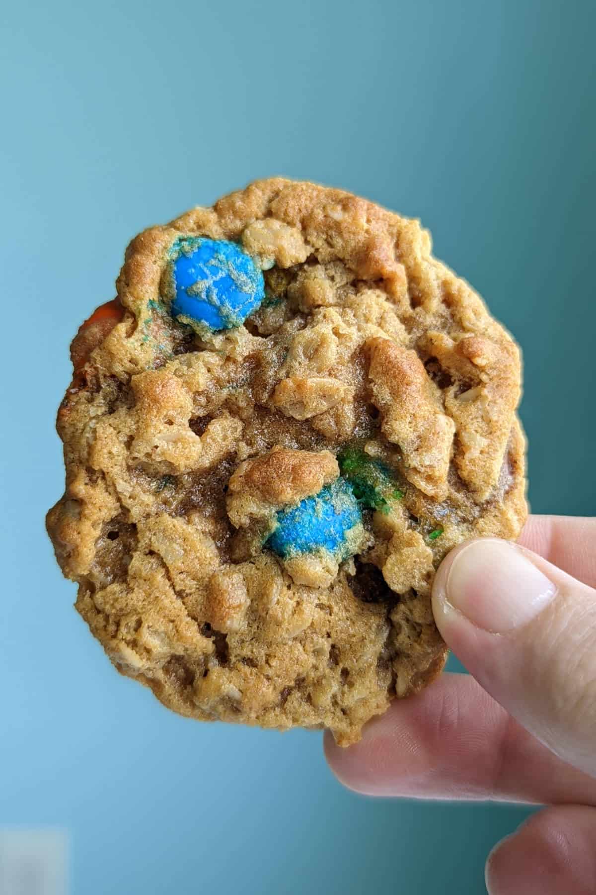 a monster cookie, held up