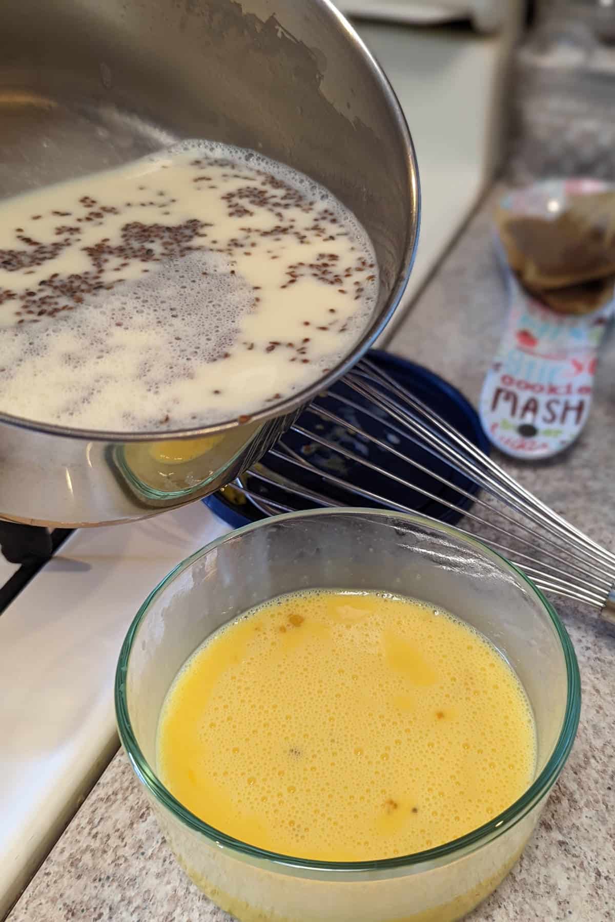 pouring warm milk into eggs