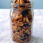 granola piled in a mason jar - text overlay for Pinterest