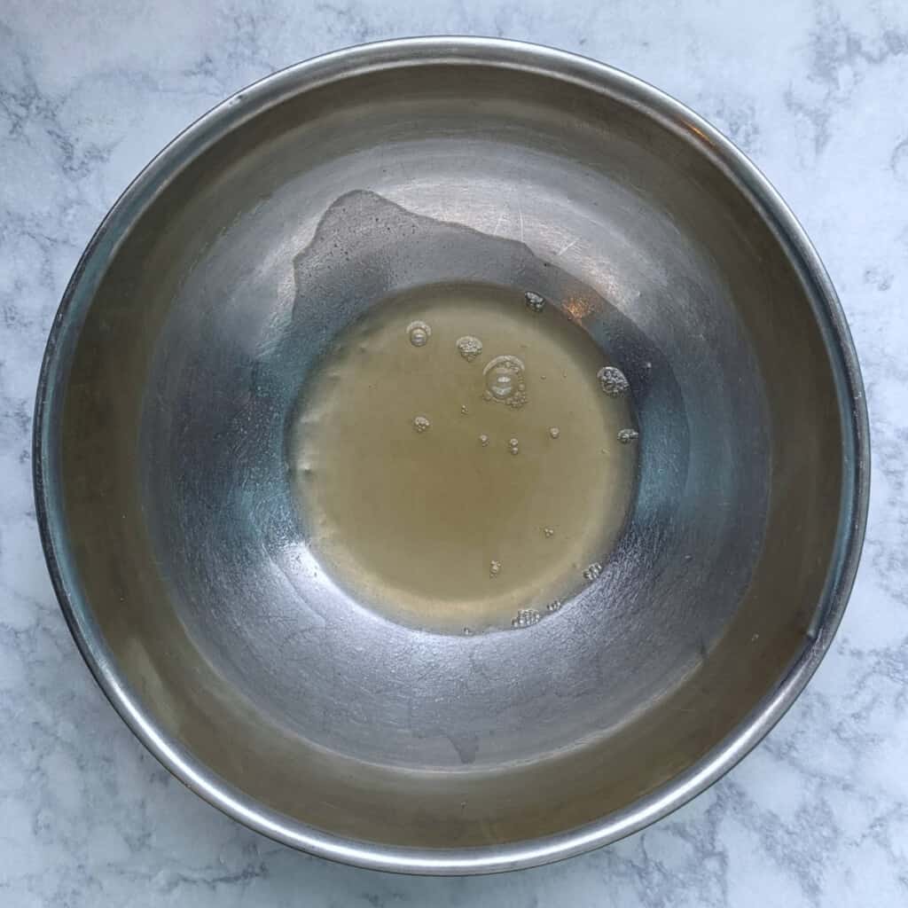 liquid from a can of chickpeas, in a large mixing bowl