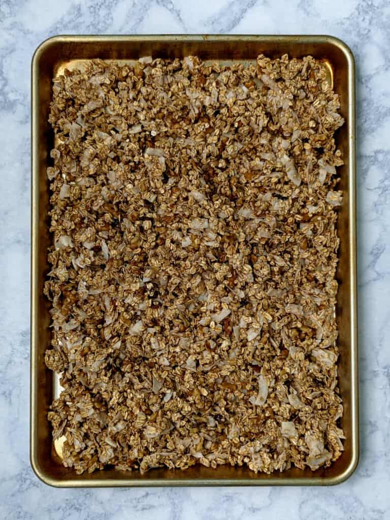 granola in a sheet pan before baking
