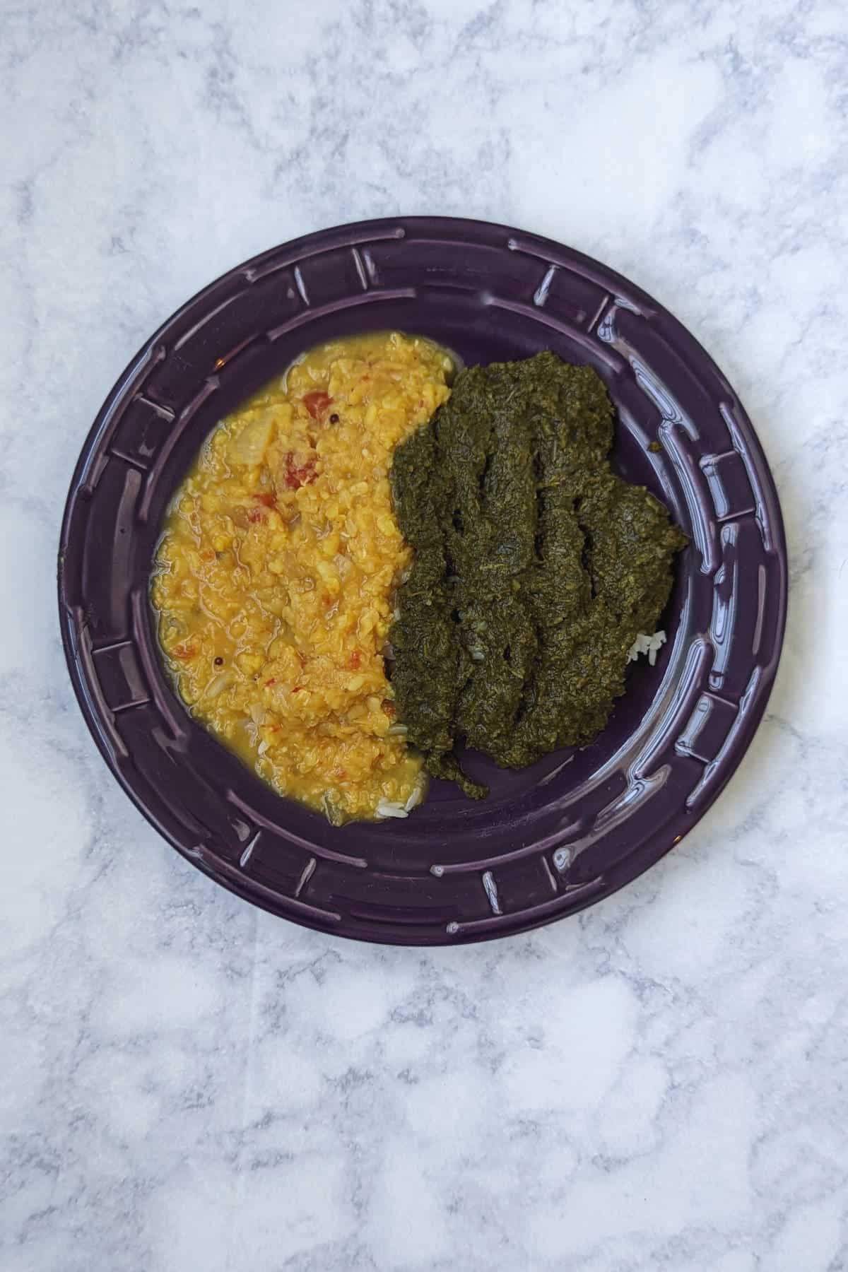 saag (Indian creamed spinach) and dal (Indian lentils) over rice, on a plate