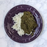 saag (Indian creamed spinach) over rice, on a plate