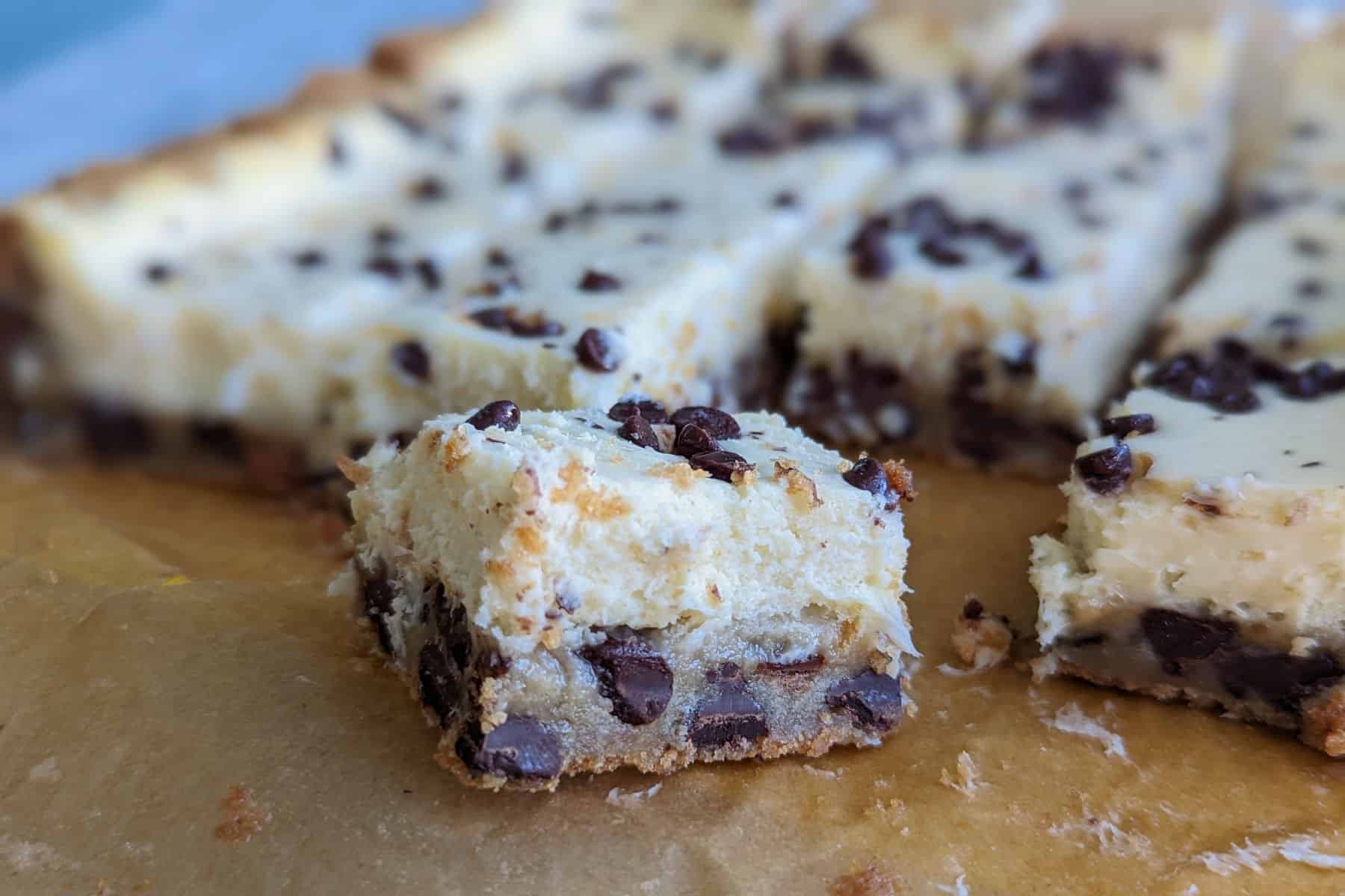 chocolate chip cookie cheesecake bars, cut, with view of layers