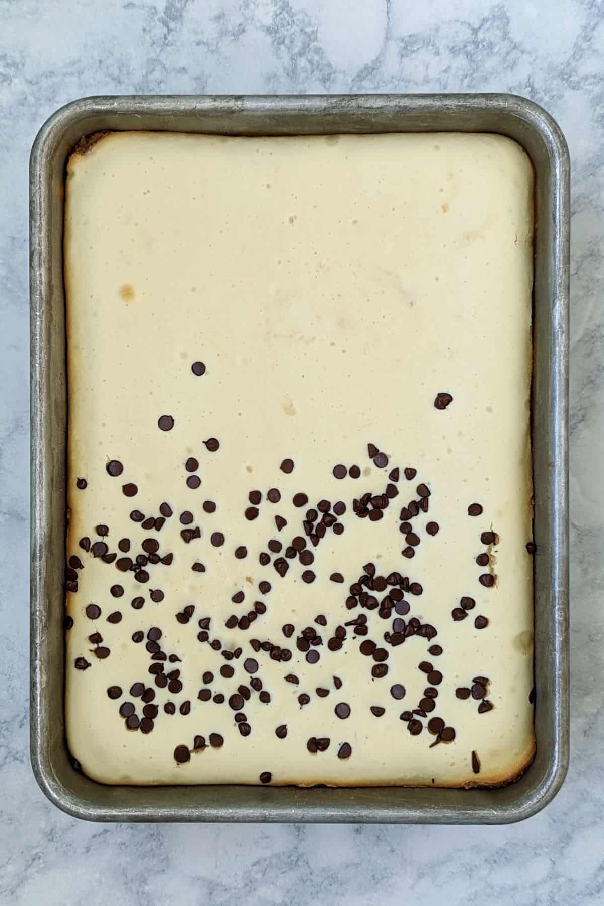 chocolate chip cookie cheesecake bars, in pan after baking