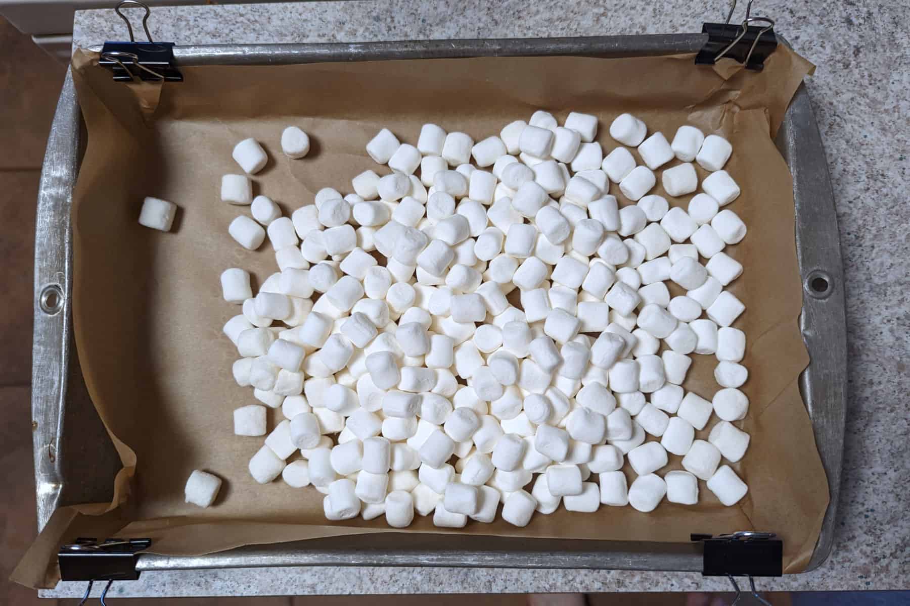 marshmallows in a parchment-lined 9x13 inch pan
