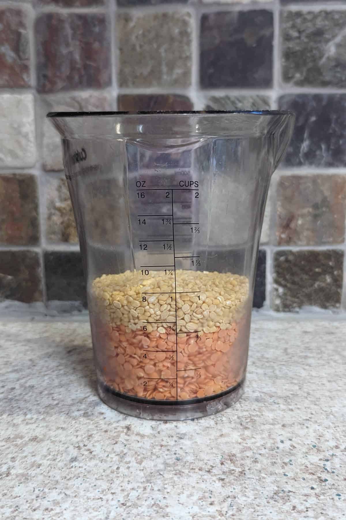 red and yellow lentils, layered in a measuring cup