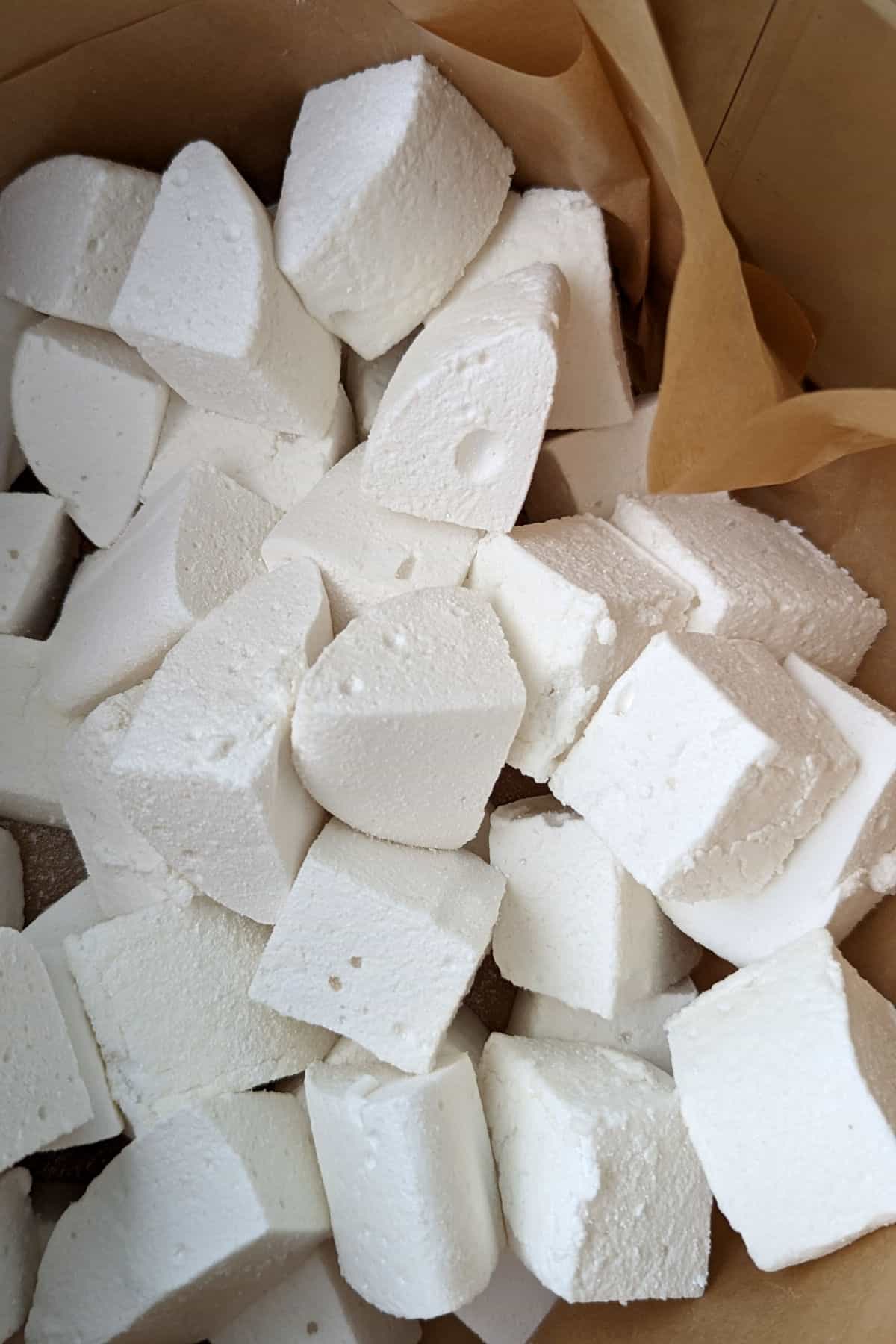cut marshmallows in a tin lined with parchment paper