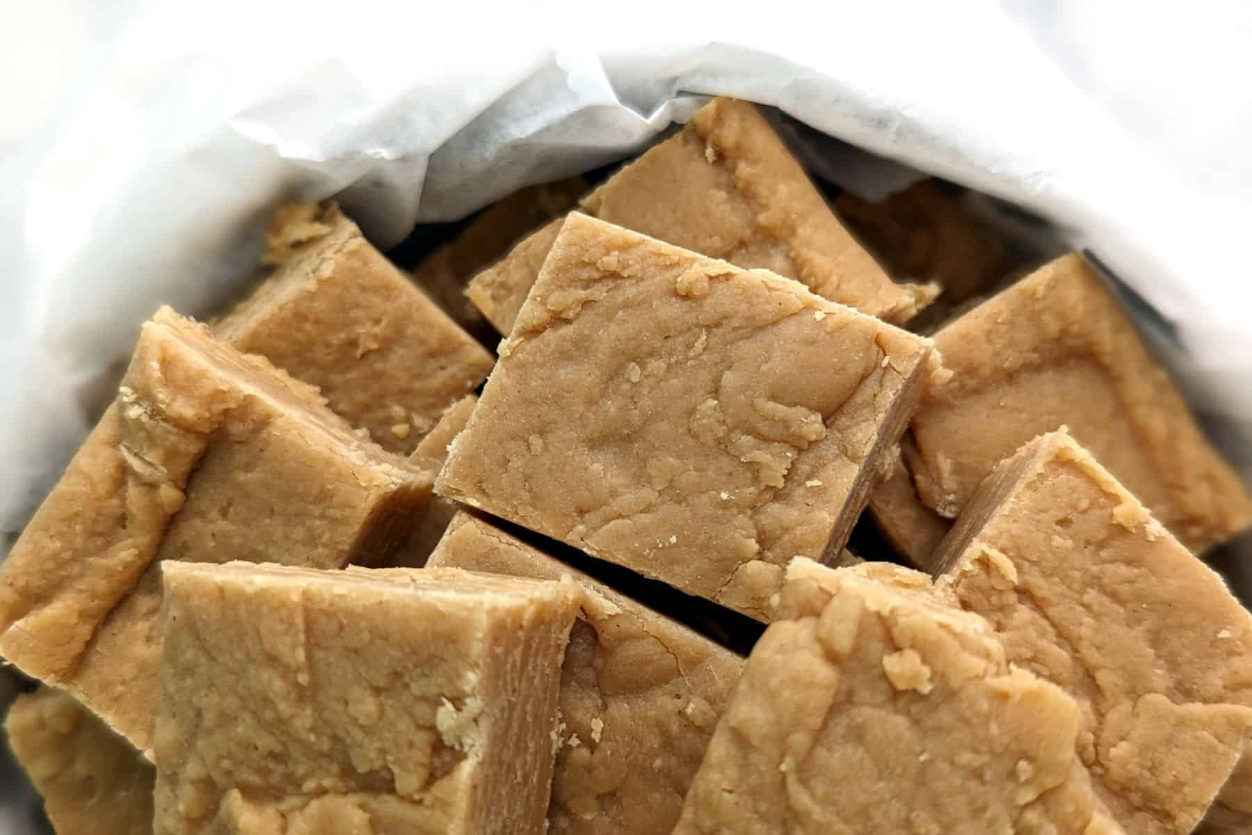 peanut butter fudge, cut into squares, in a tin