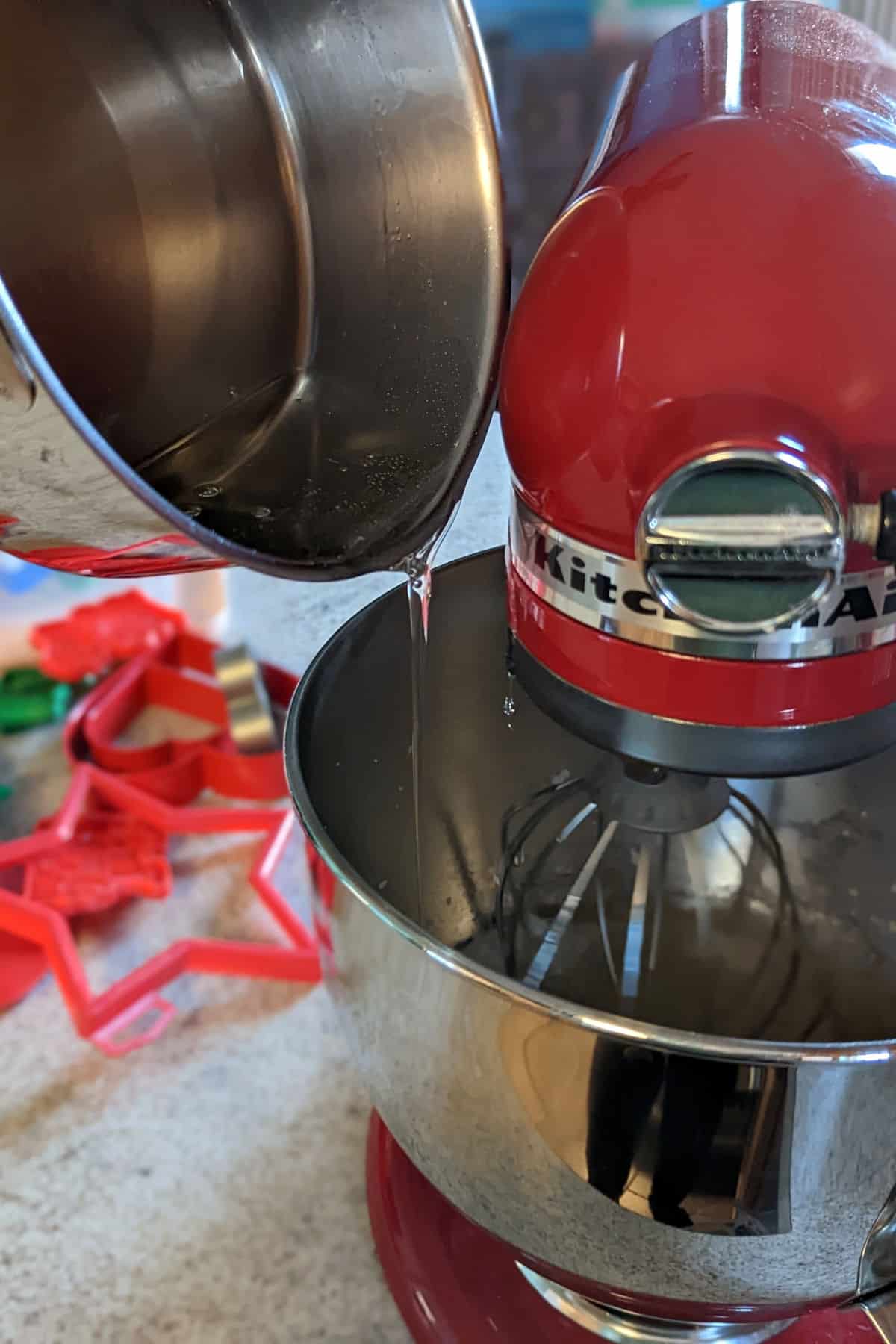 drizzling sugar syrup into stand mixer bowl while it runs