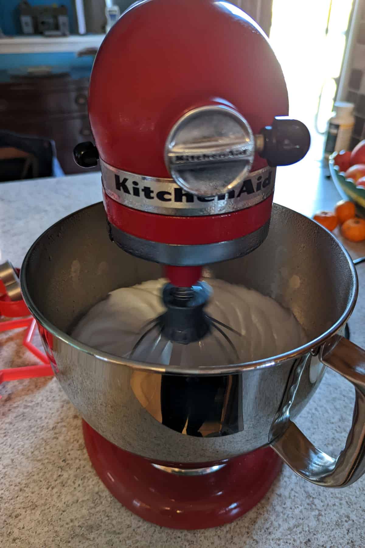 marshmallow fluff in stand mixer while whipping, having become foamy after 2 minutes