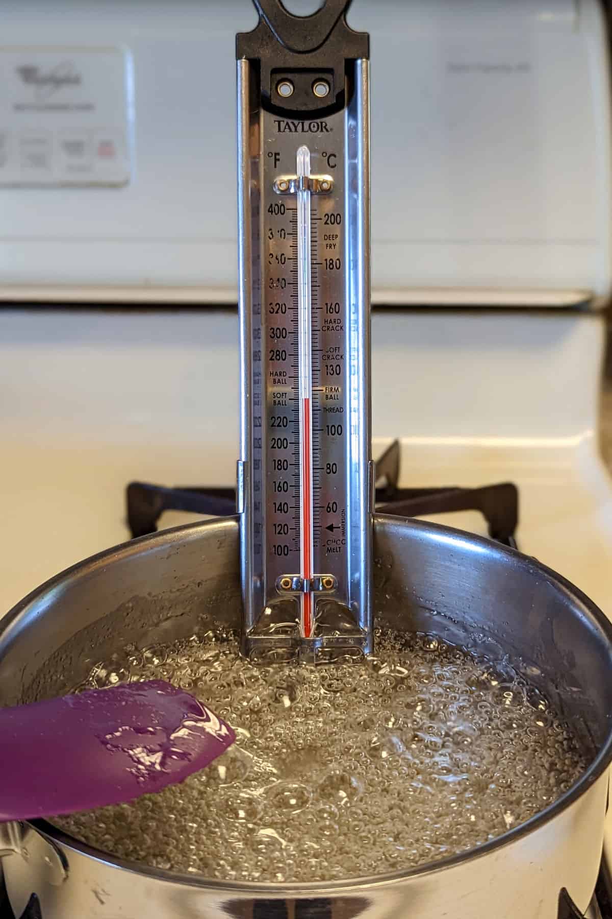 thermometer in sugar syrup registering 240F