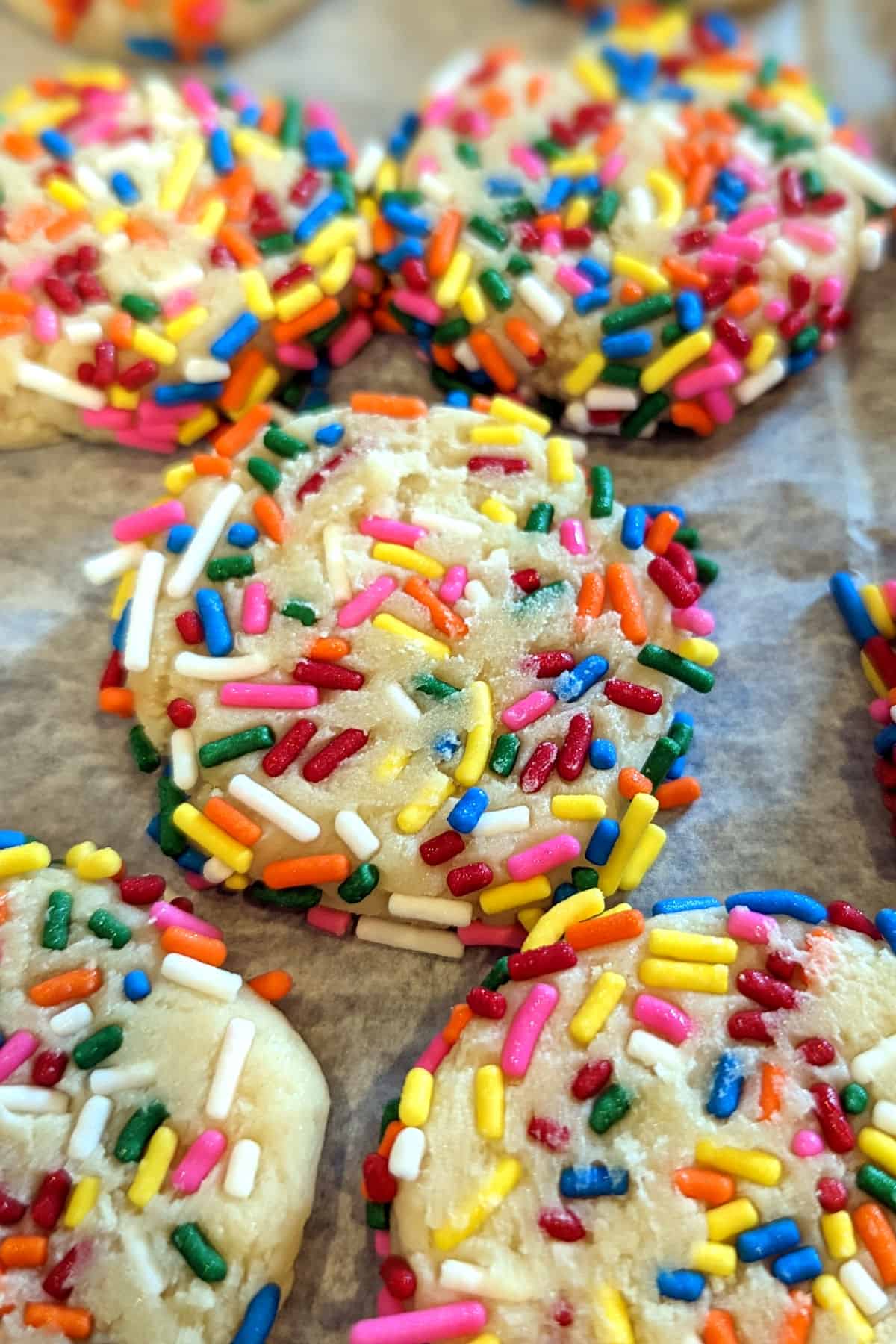 frozen sprinkle cookie dough crowded together on a baking sheet