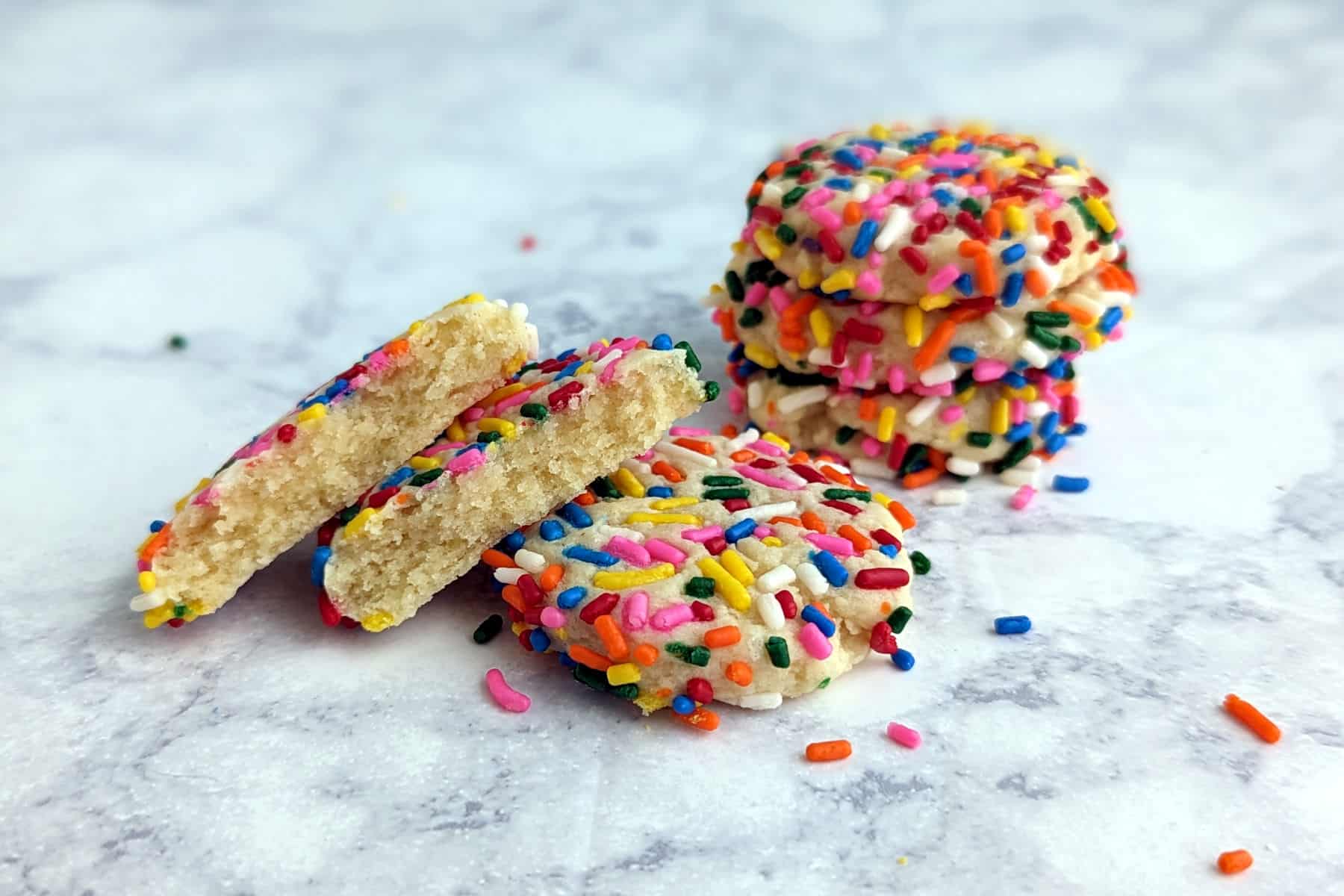 sprinkle cookies, with one broken open to show interior texture