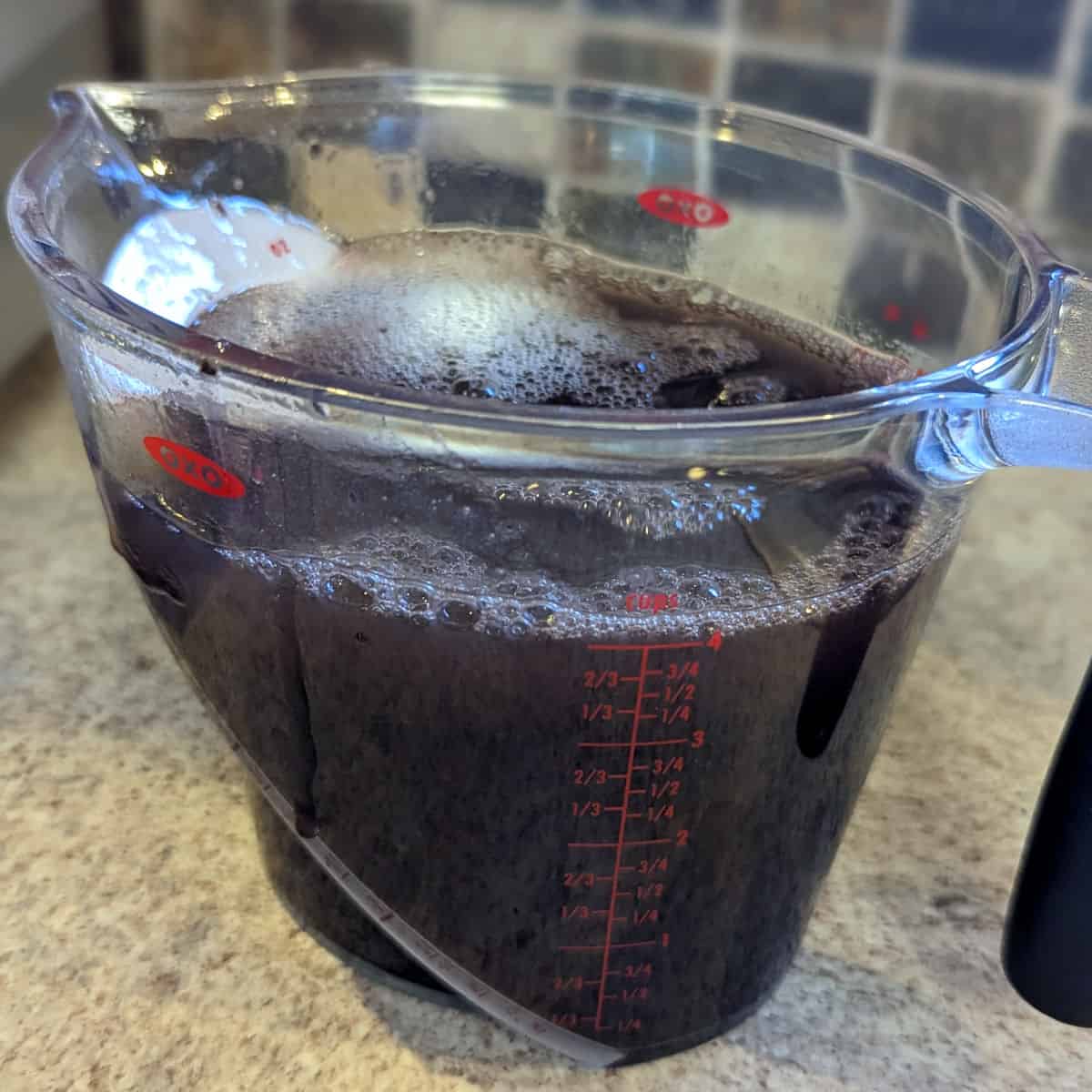 cooked beans in a 4 cup measuring cup, with liquid added to reach 4 cups volume