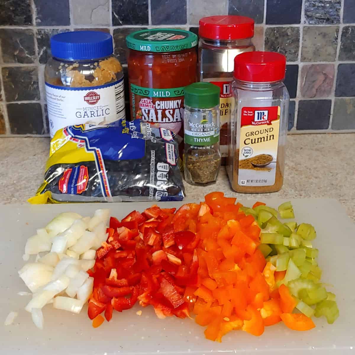 dry ingredients for black bean soup, with chopped onions, peppers, and celery