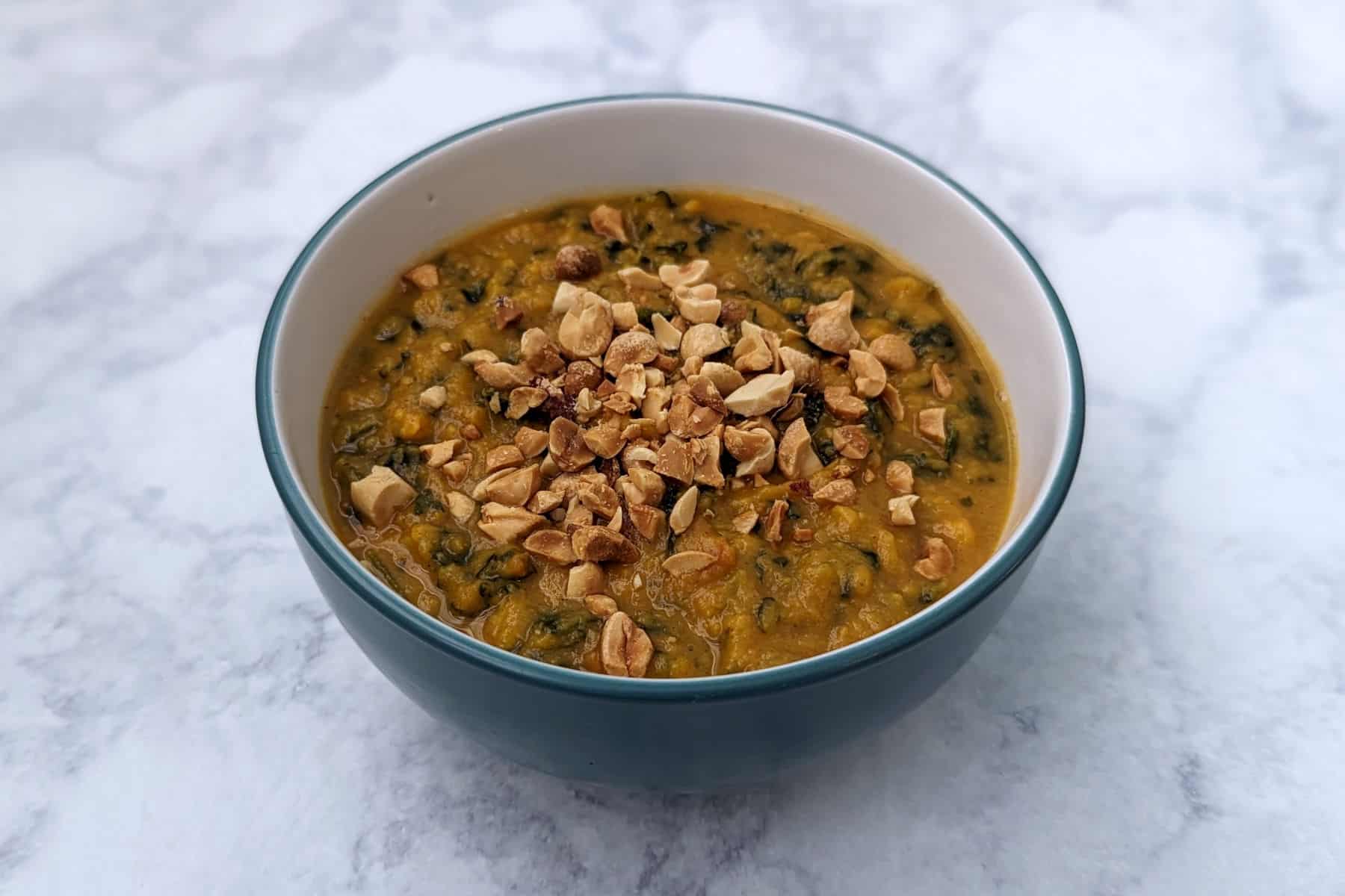 sweet potato peanut stew, topped with peanuts, in a bowl