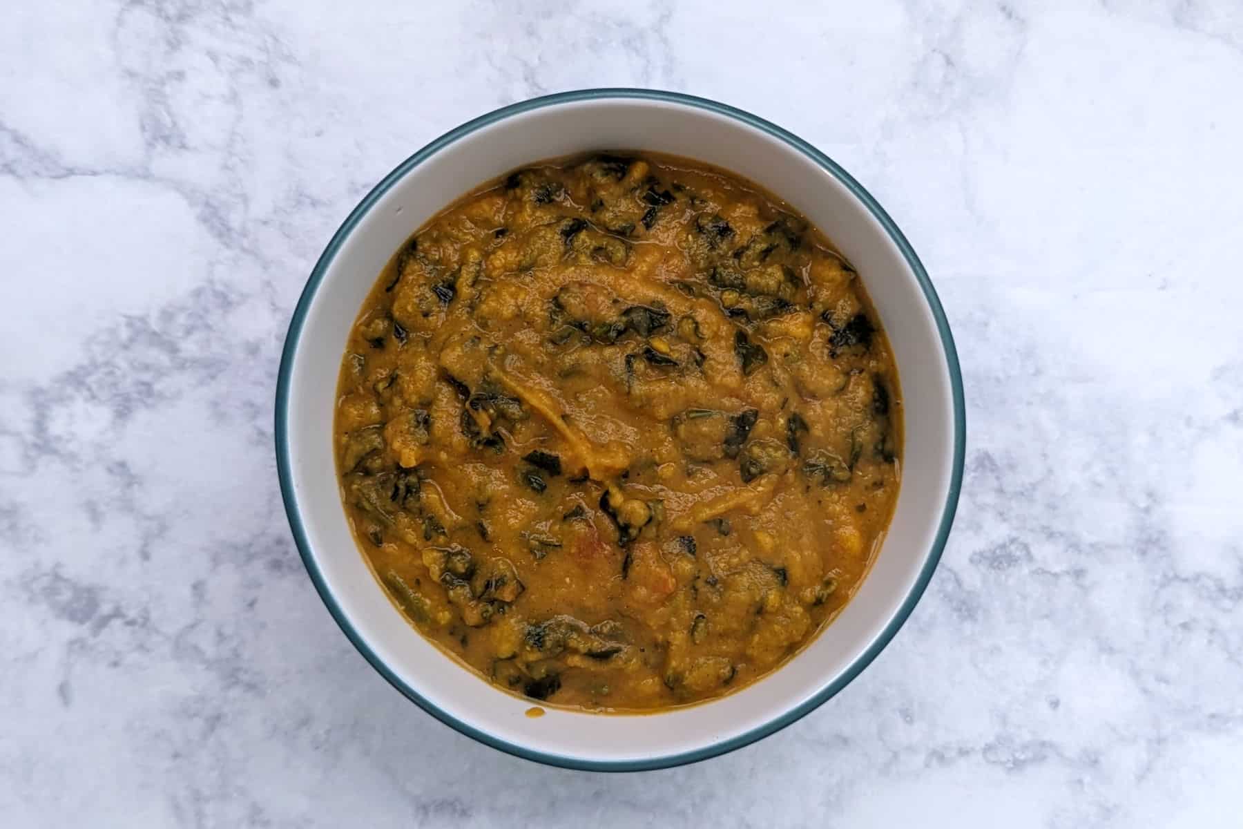 sweet potato peanut stew with greens, in a bowl