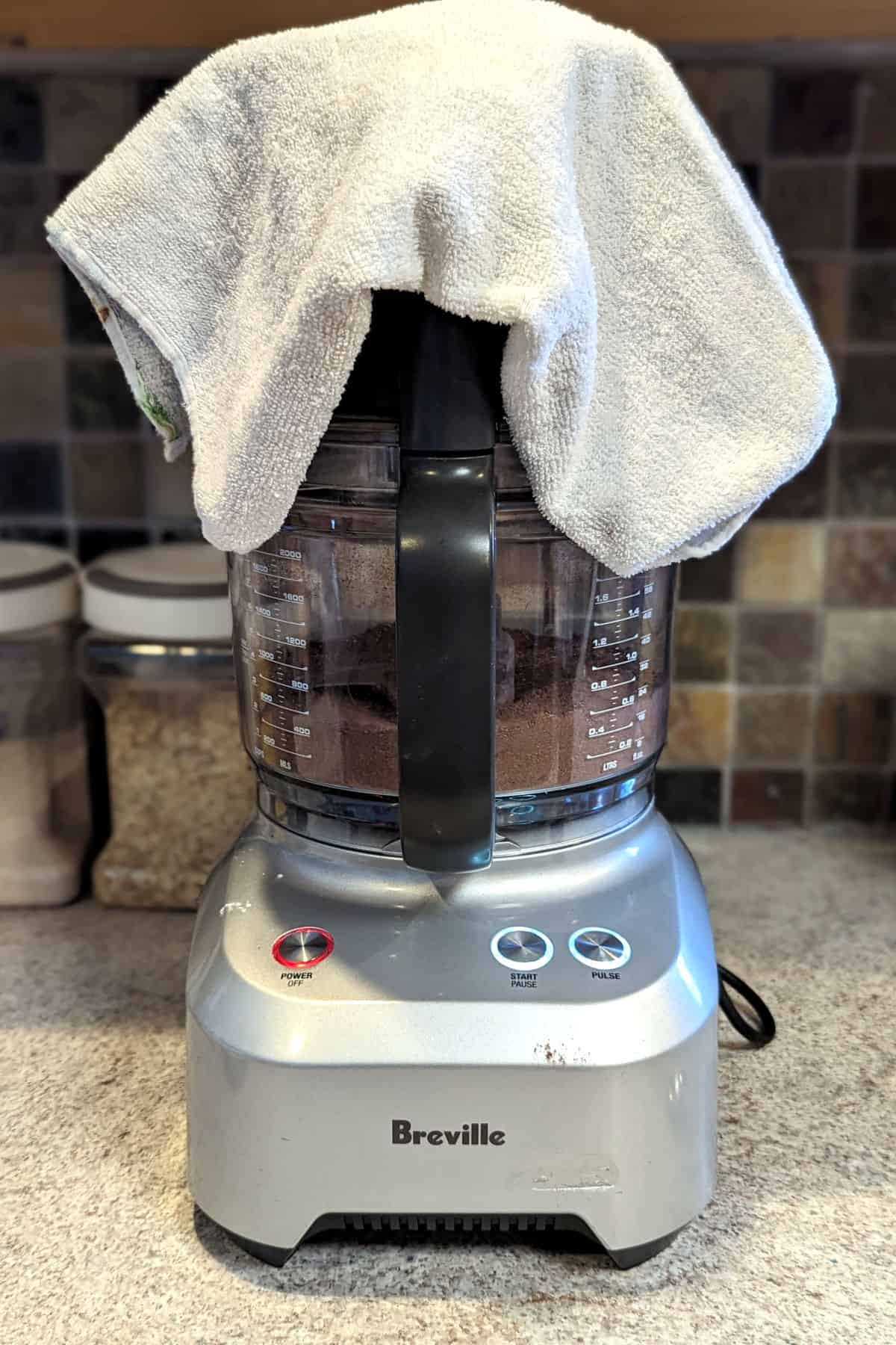 food processor, with a towel over the top