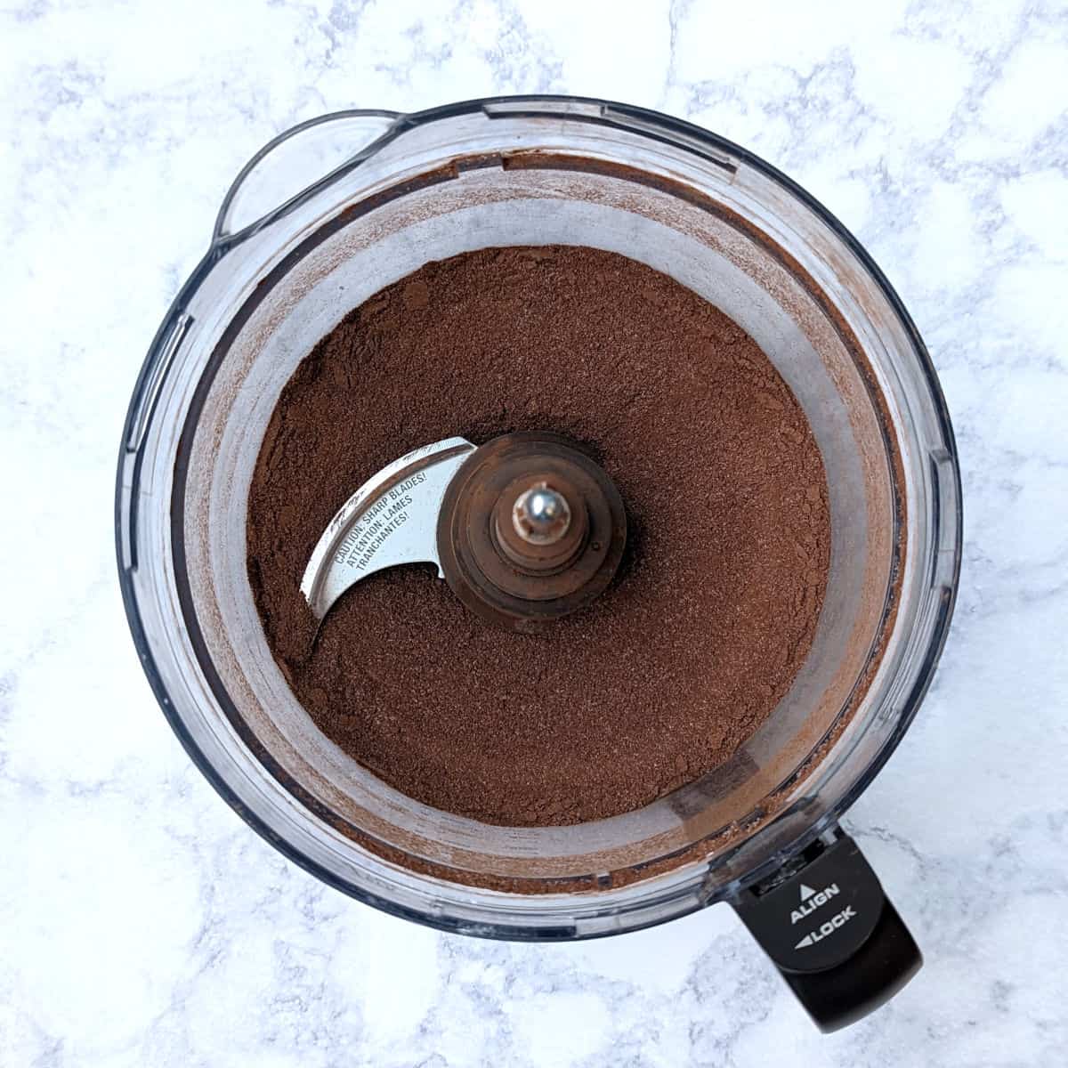 ingredients for hot chocolate mix, blended together in a food processor bowl