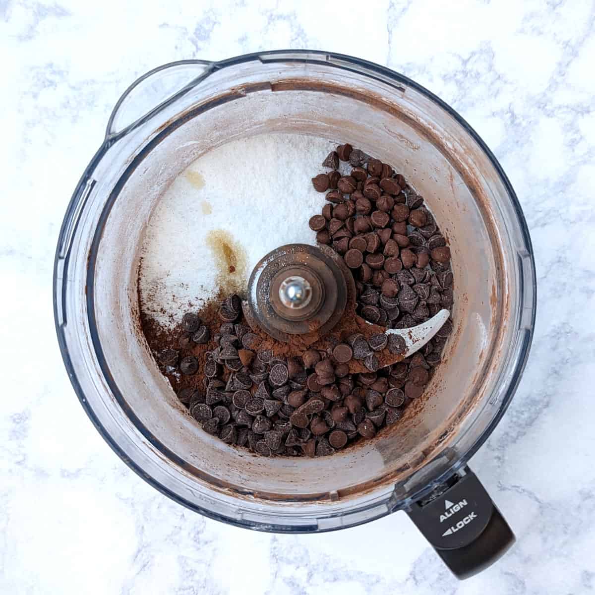 ingredients for hot chocolate mix, in a food processor bowl before blending