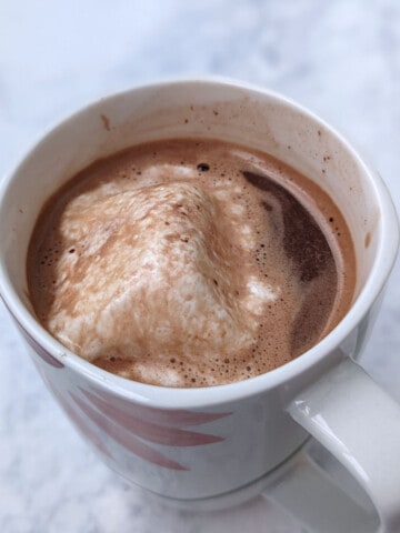 hot chocolate in a mug, with melted marshmallow