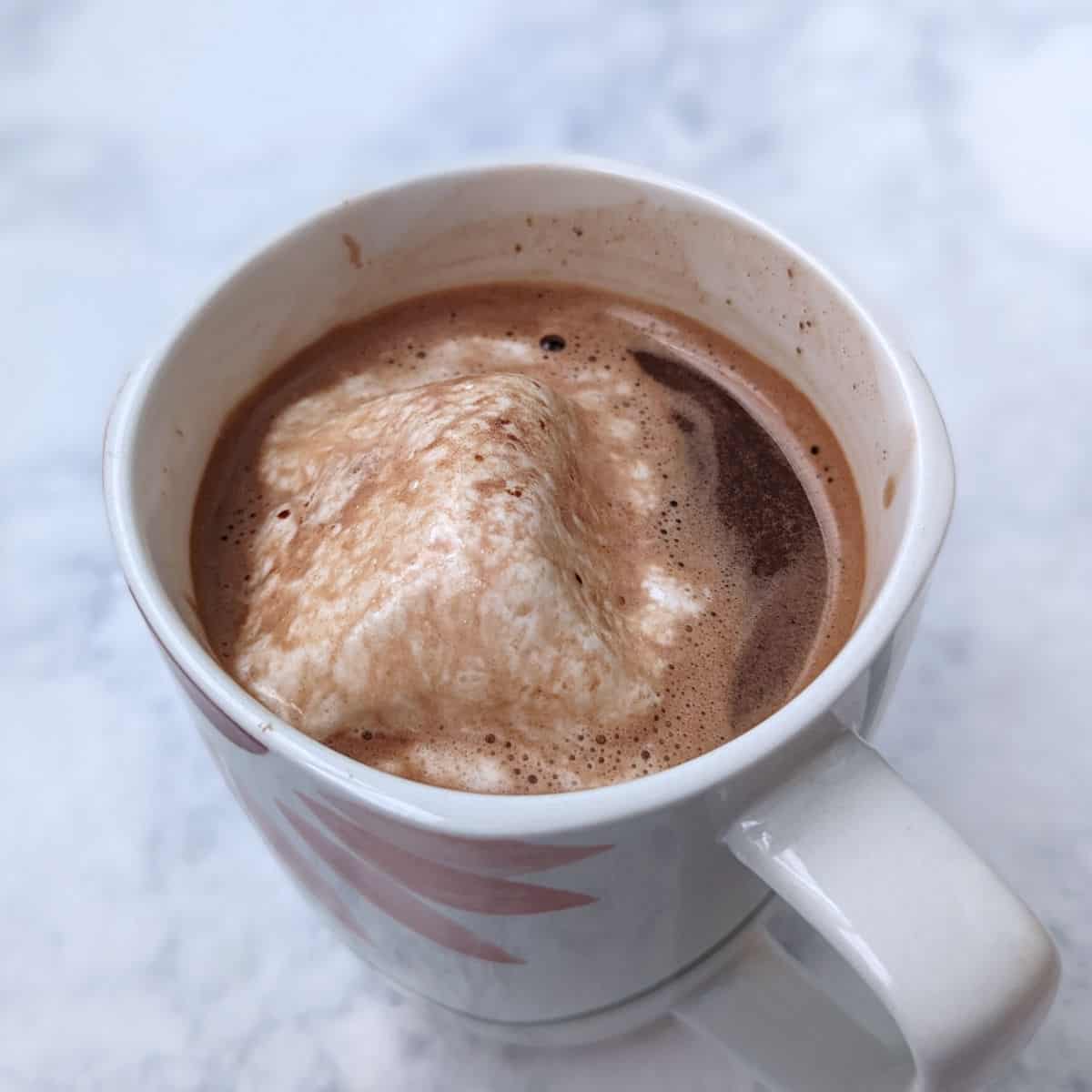 hot chocolate in a mug, with melted marshmallow