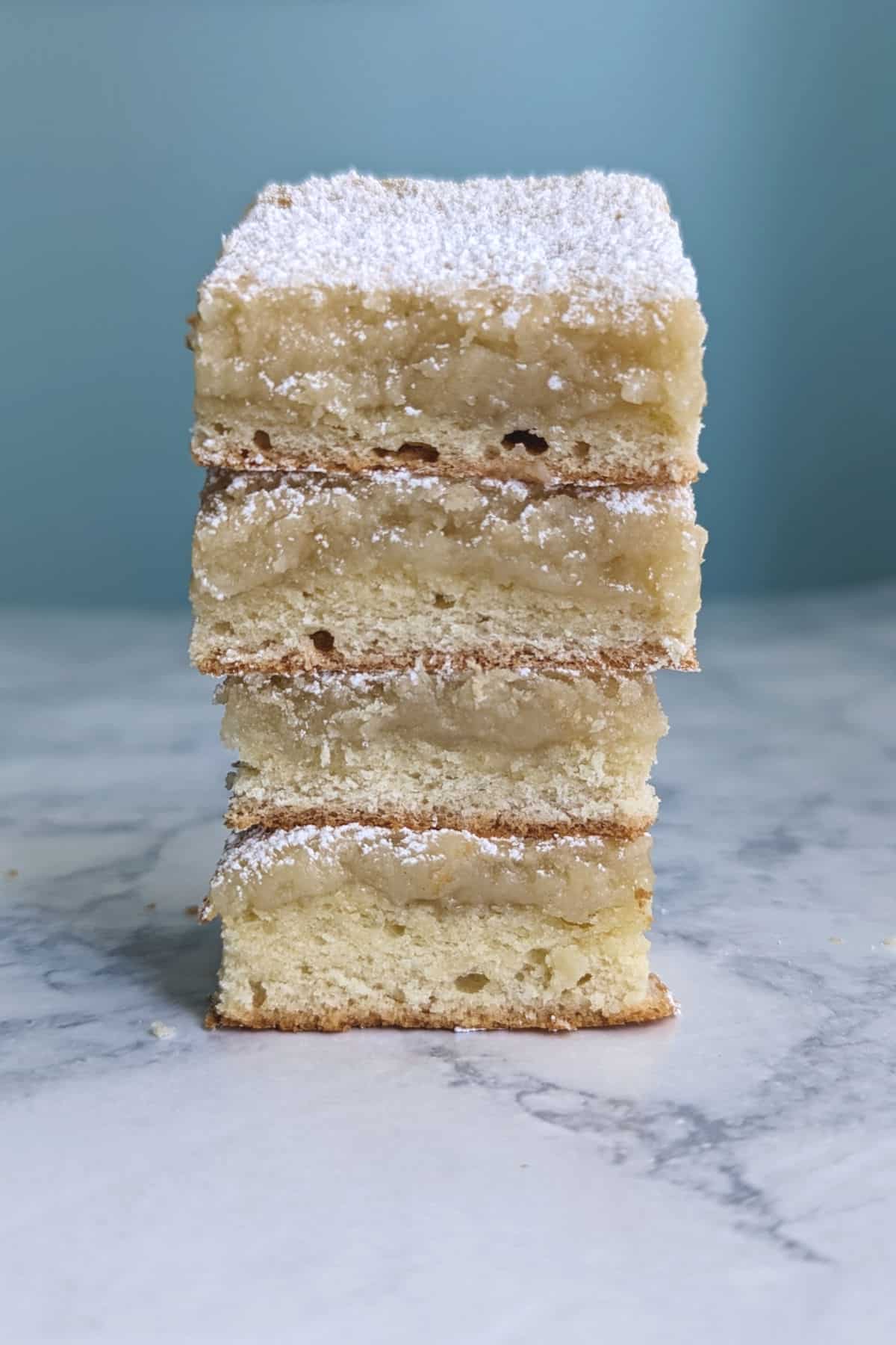 a tall stack of 4 slices of gooey butter cake