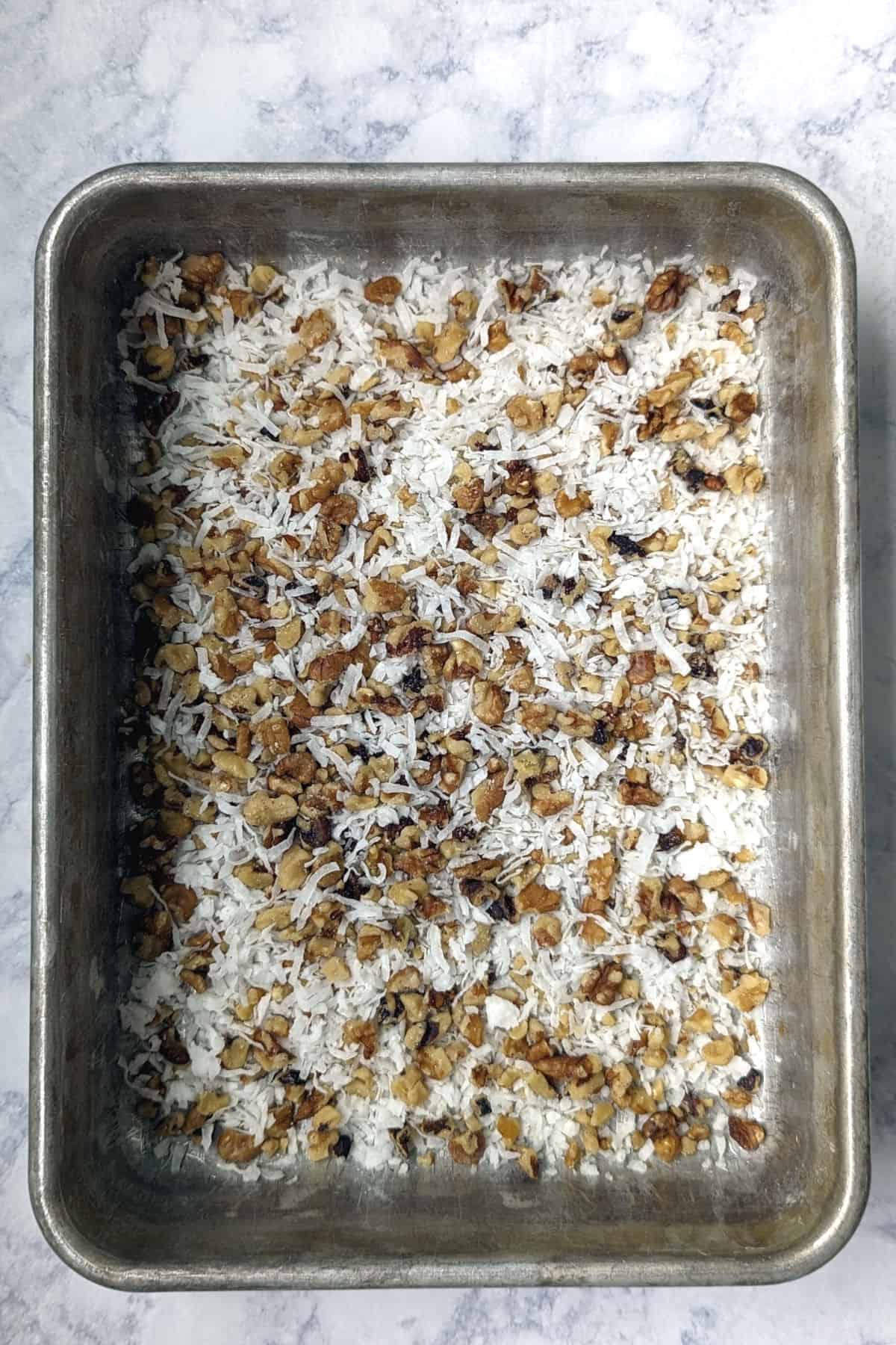 chopped walnuts and coconut in a 9x13-inch pan