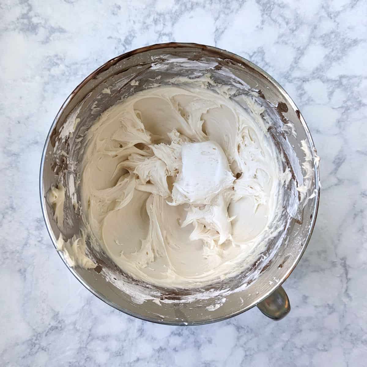 cream cheese frosting in a stand mixer bowl