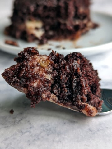 bite of earthquake cake on a fork in front of a plate