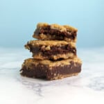 a short stack of fudgy butterscotch bars, with one torn open to show texture