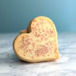 shortbread cookie heart, on its side, resting on a stack of cookies