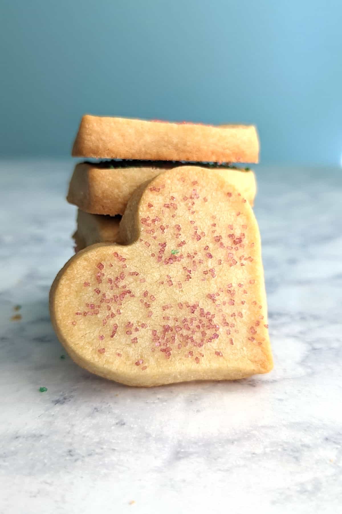 shortbread cookie heart, resting on a stack of cookies