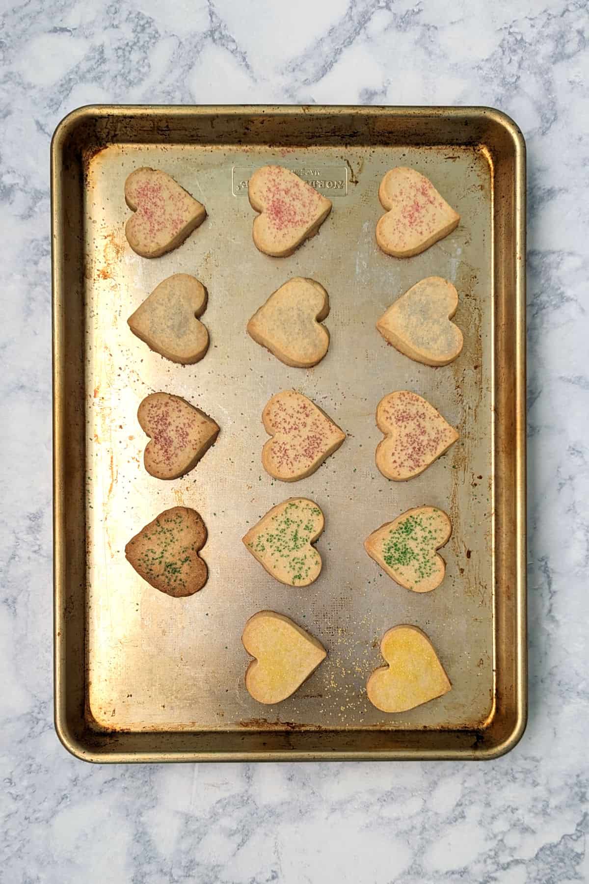 shortbread cookie hearts, on a sheet pan, after baking