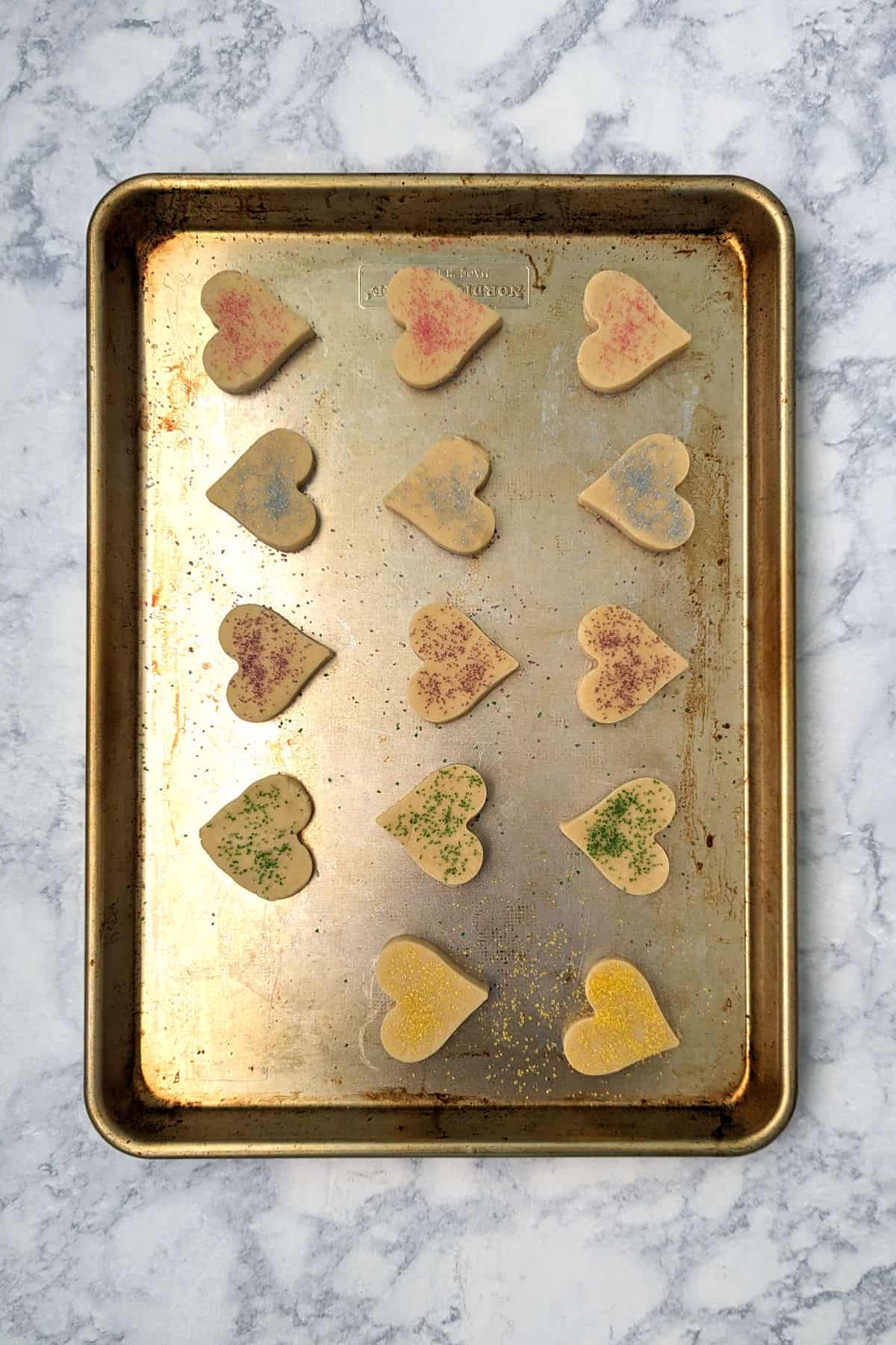 shortbread cookie dough shapes, on a half sheet pan, before baking