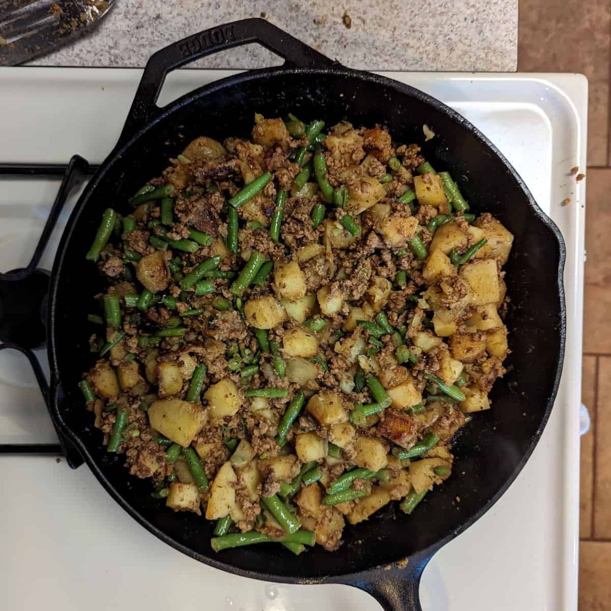 breakfast sausage hash, cooked, in a cast iron skillet right before serving