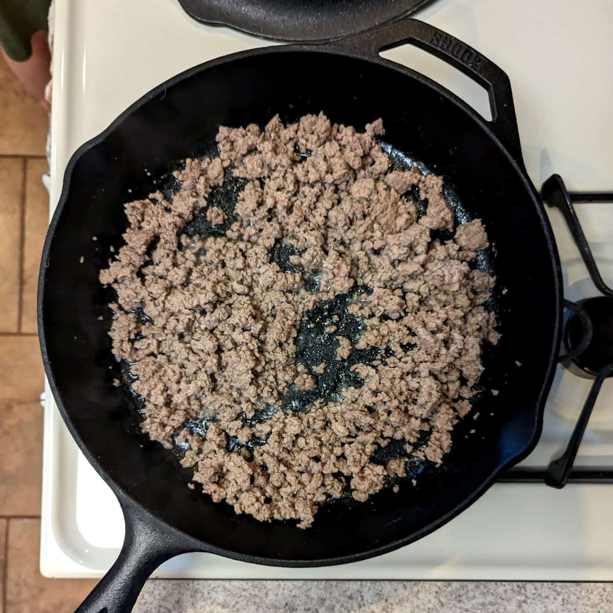 cooked ground pork, in a cast iron skillet