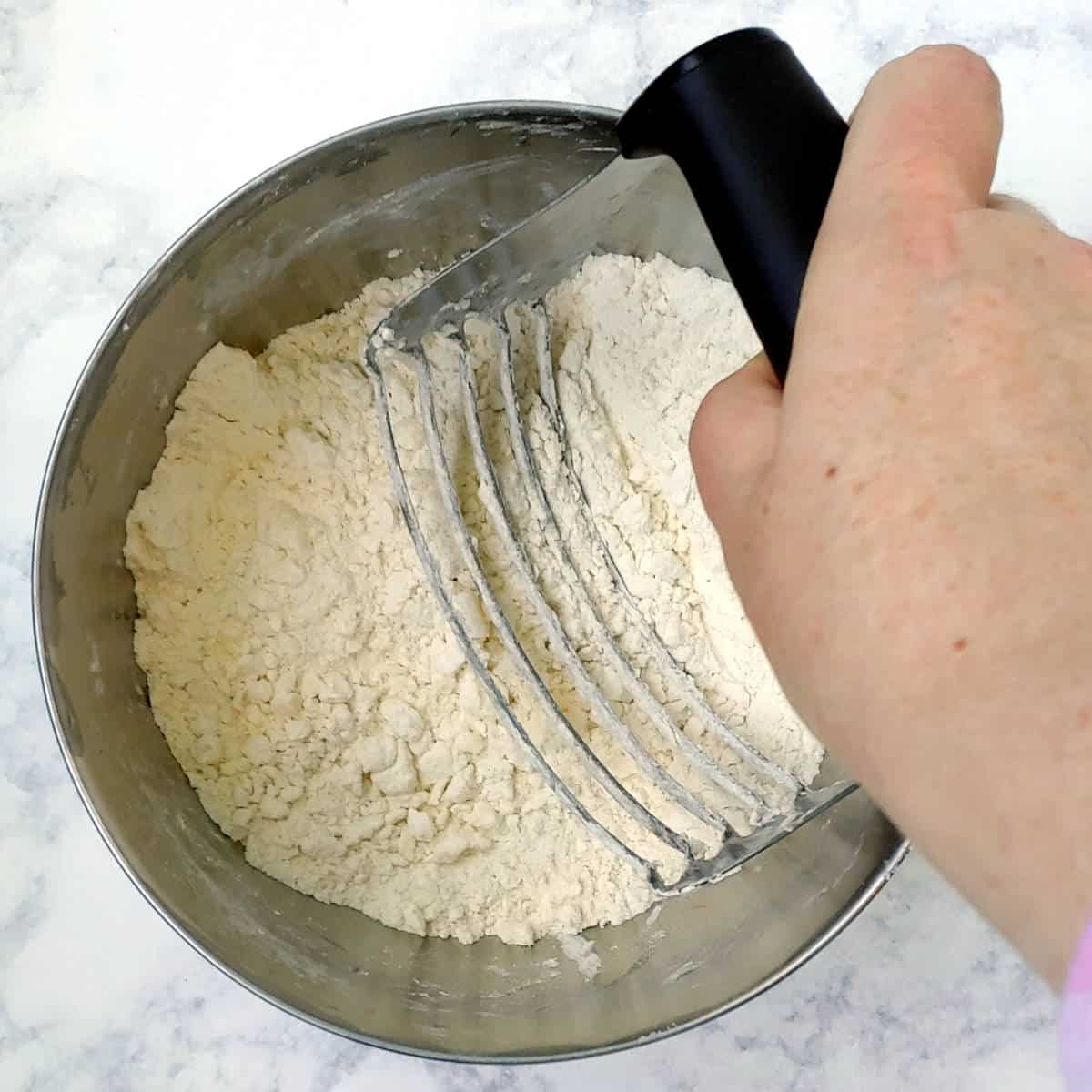 cutting butter into flour and salt with a pastry cutter