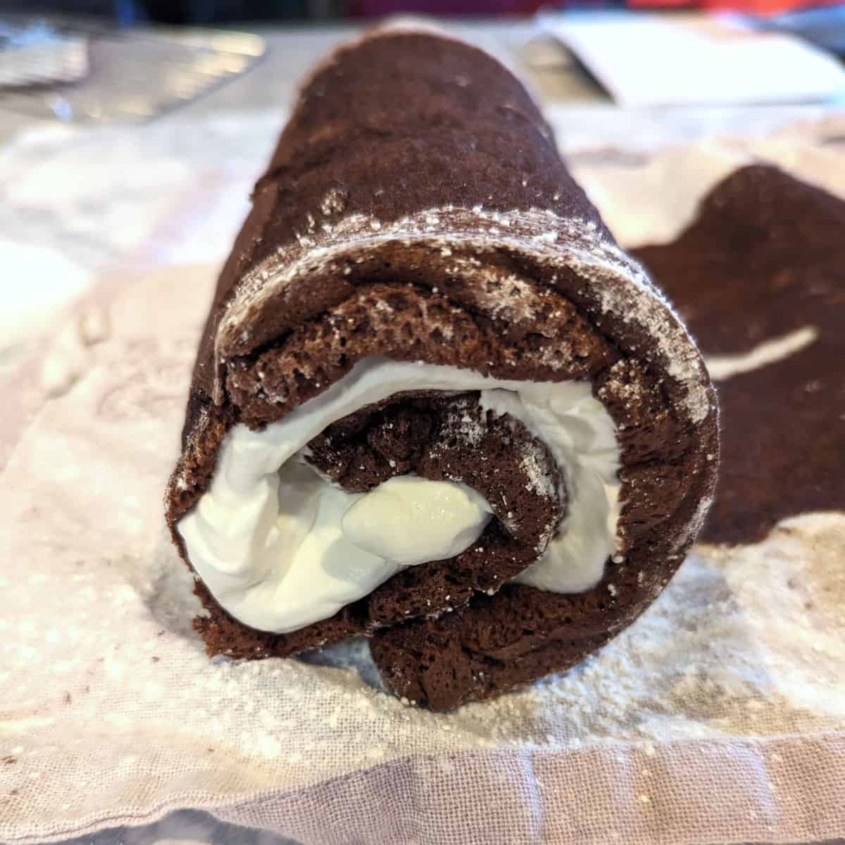 chocolate cake rolled up with whipped cream in the middle